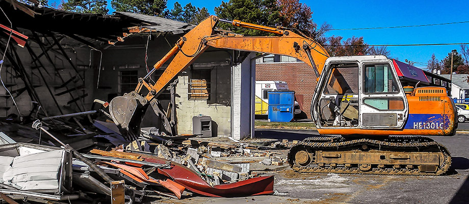 Charlotte Demolition Contractors, W.C. Black and Sons, Inc., demolishing an old Gas Station with an excavator in Charlotte, NC.